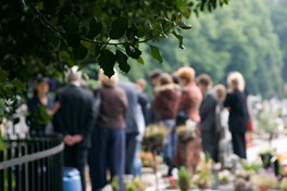 familie neemt afscheid bij het graf